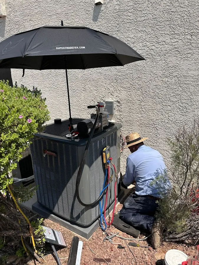 HVAC technician performing outdoor AC maintenance in Rusk